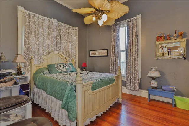 a bedroom with bed and wooden floor