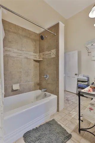 a bathroom with a bathtub and a shower