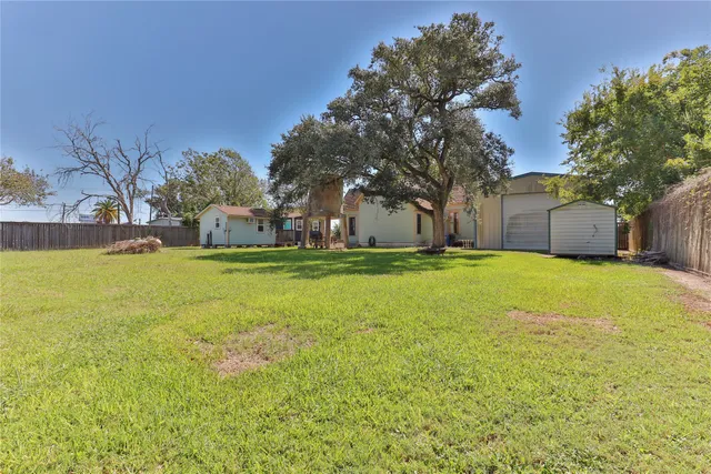 a view of a house with backyard porch and sitting area