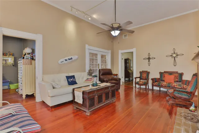 a living room with furniture and a chandelier