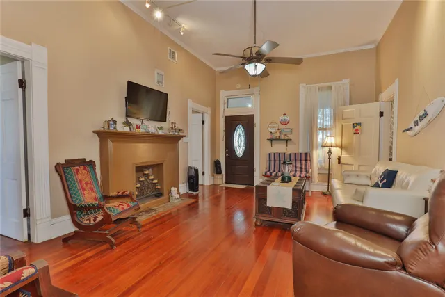 a living room with furniture a fireplace and a flat screen tv