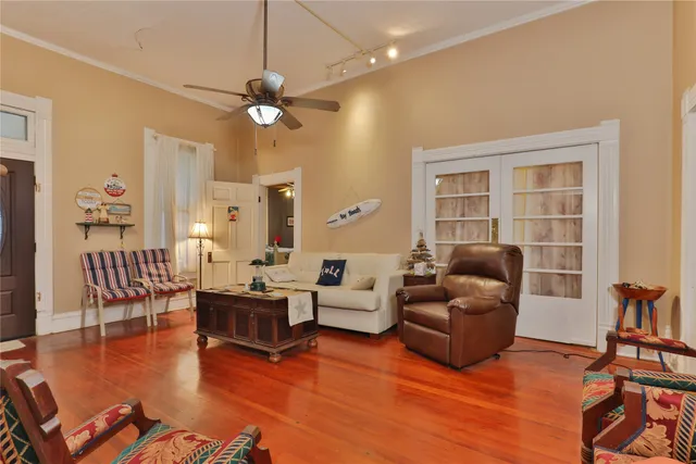 a living room with furniture and a wooden floor