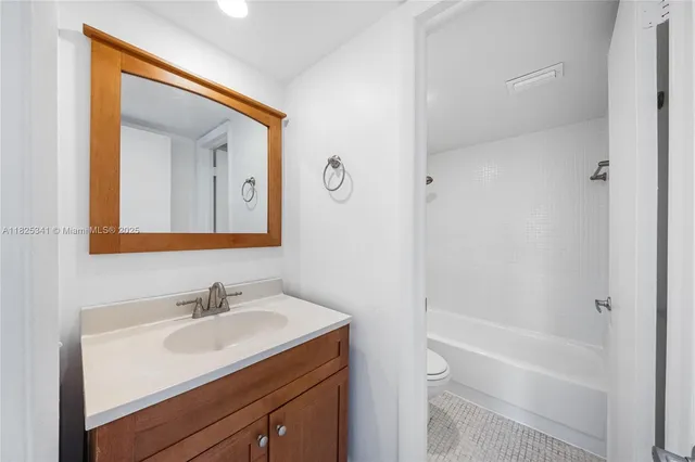 a bathroom with a sink toilet a vanity and shower
