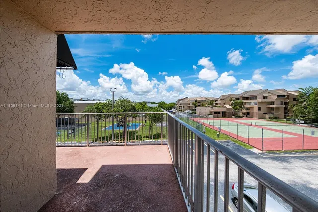 a view of a balcony with wooden floor