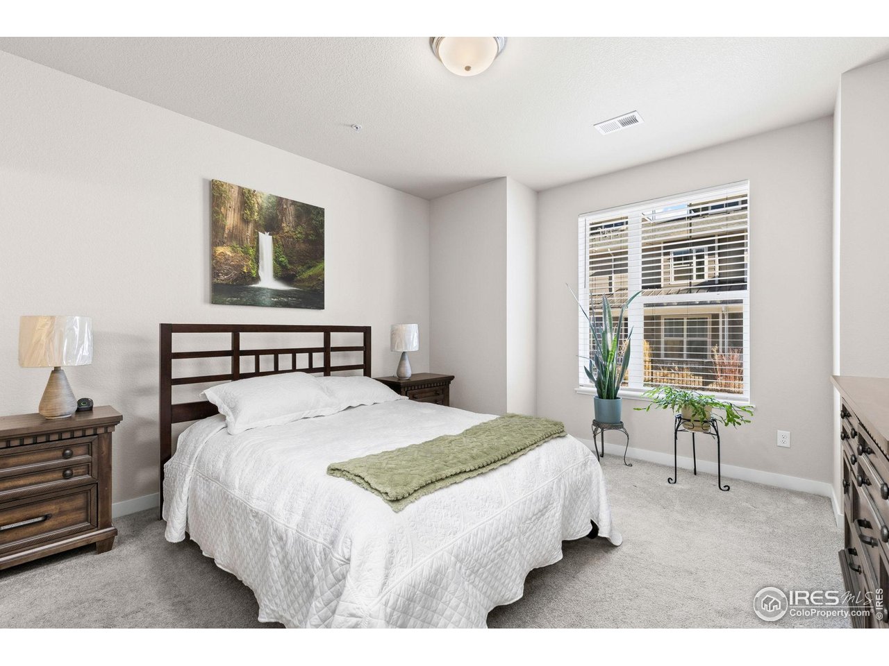 330 High Point Drive, Unit B103 Longmont, CO 80504 - Photo 12 of 18 a bedroom with a bed and chair