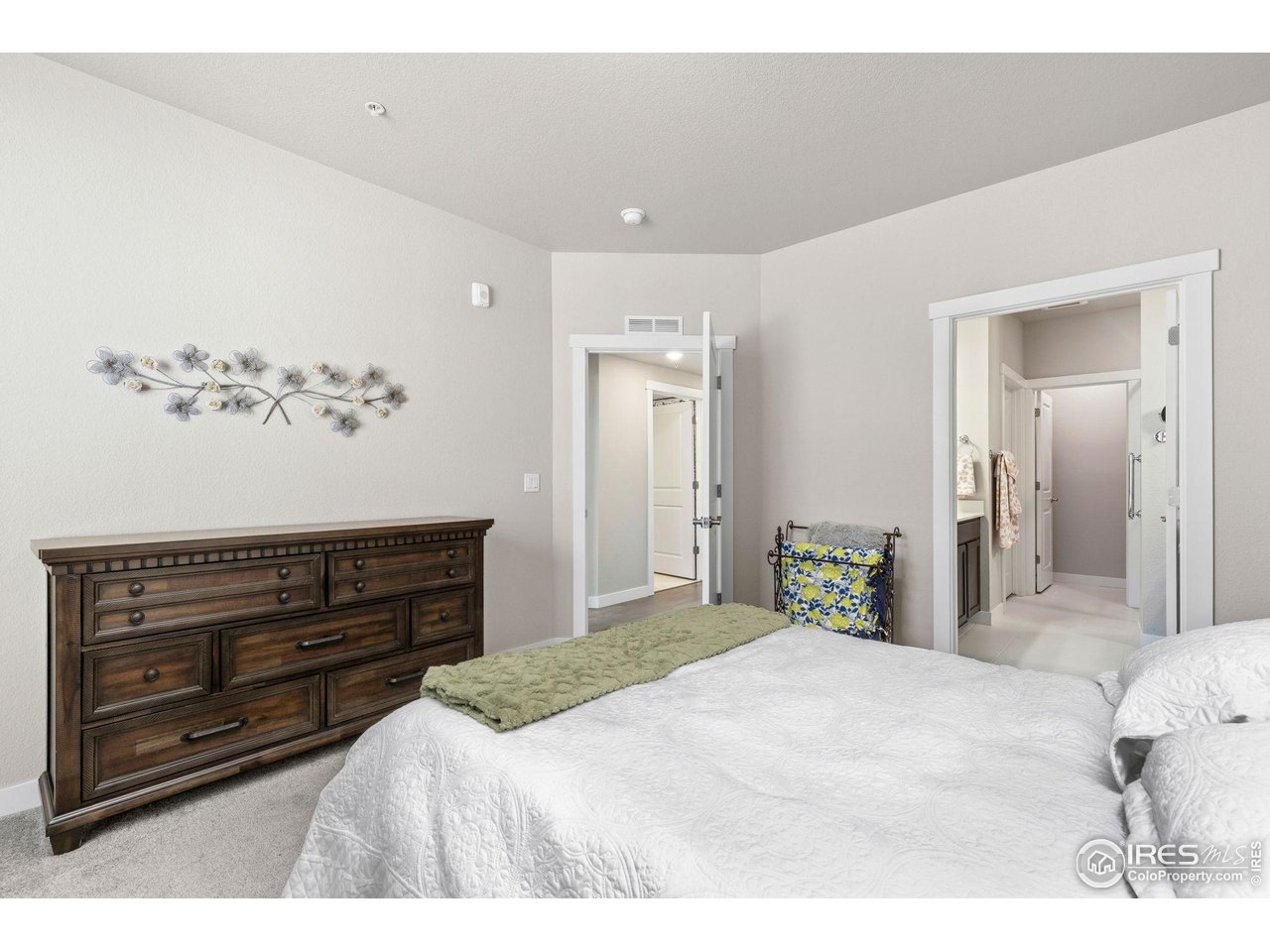 330 High Point Drive, Unit B103 Longmont, CO 80504 - Photo 13 of 18 a bedroom with a bed and a dresser