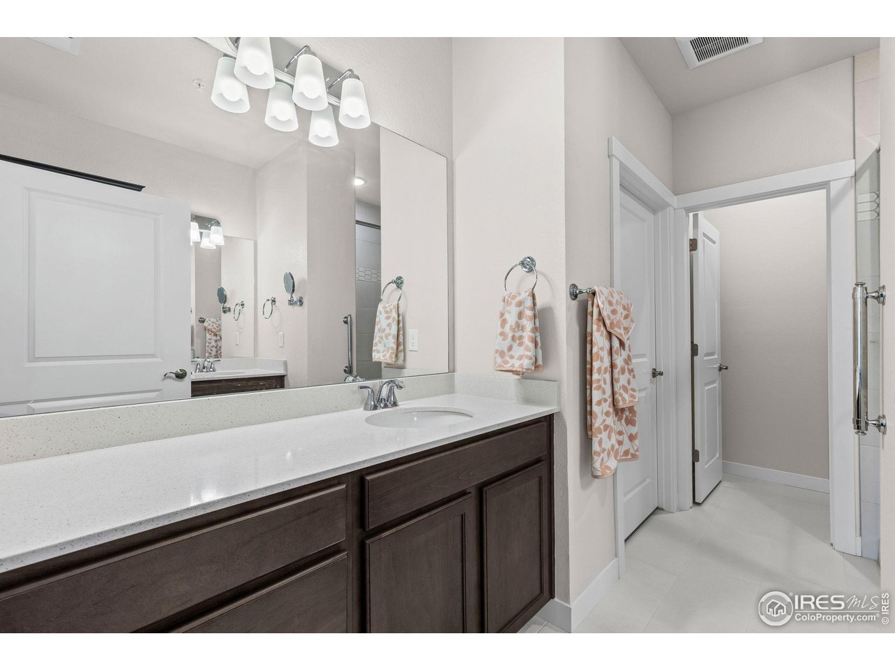 330 High Point Drive, Unit B103 Longmont, CO 80504 - Photo 15 of 18 a bathroom with a sink a shower and a mirror