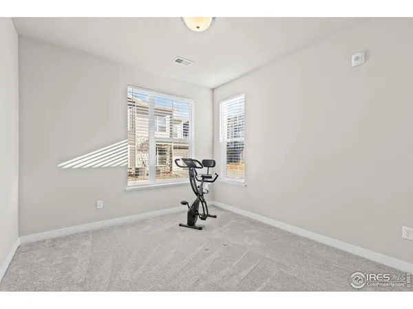 a bathroom with a granite countertop sink a toilet and a mirror
