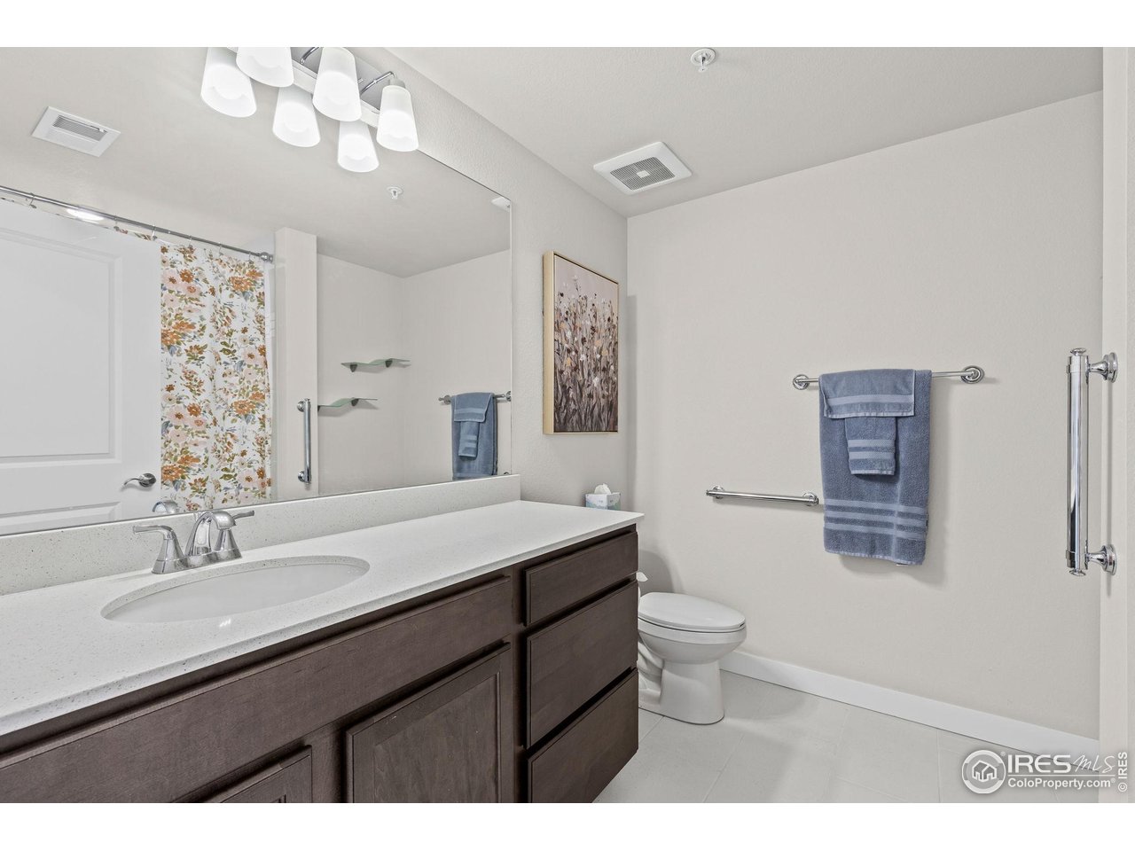 330 High Point Drive, Unit B103 Longmont, CO 80504 - Photo 17 of 18 a bathroom with a granite countertop sink a toilet and a mirror