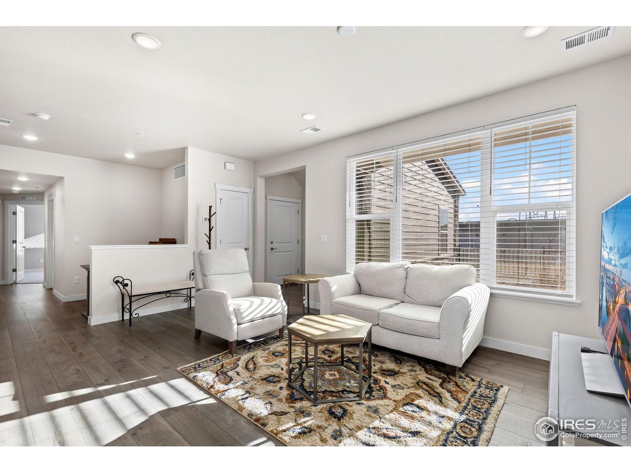 330 High Point Drive, Unit B103 Longmont, CO 80504 - Photo 5 of 18 a living room with furniture and a large window