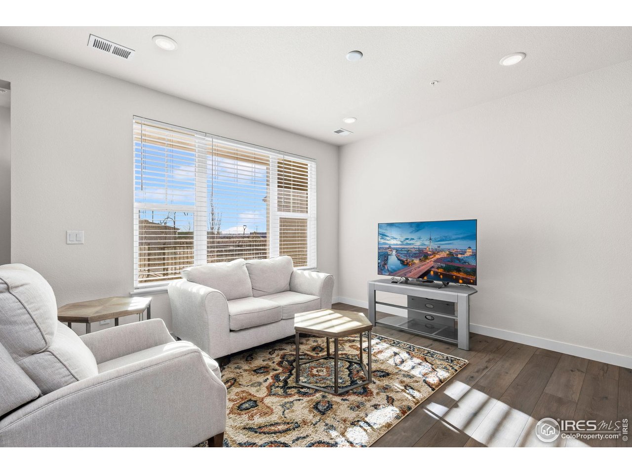 330 High Point Drive, Unit B103 Longmont, CO 80504 - Photo 6 of 18 a living room with furniture and a flat screen tv