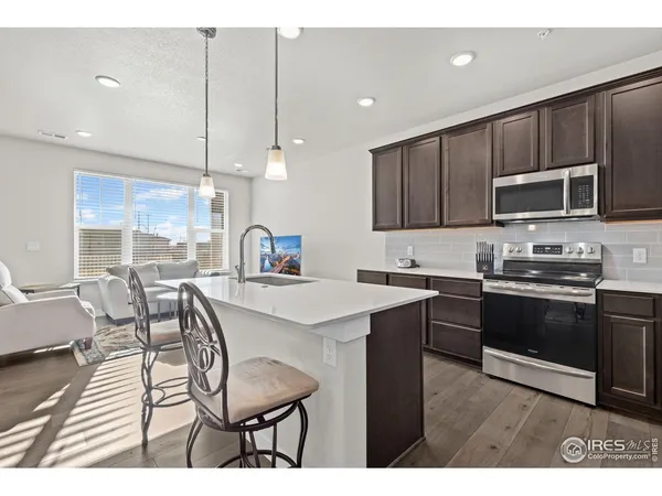 a open kitchen with a sink and cabinets