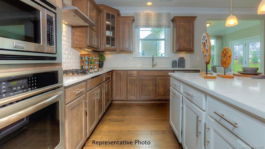 3377 Friendship Street Indian Land, SC 29707 - Photo 11 of 44 a kitchen with stainless steel appliances a sink stove and cabinets