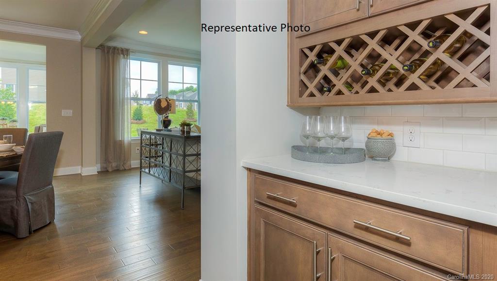 3377 Friendship Street Indian Land, SC 29707 - Photo 15 of 44 a kitchen with a table chairs and a potted plant