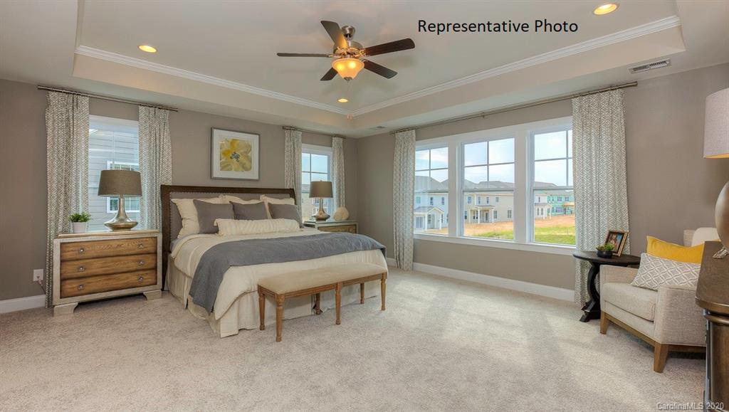 3377 Friendship Street Indian Land, SC 29707 - Photo 25 of 44 a bedroom with a bed and a chandelier