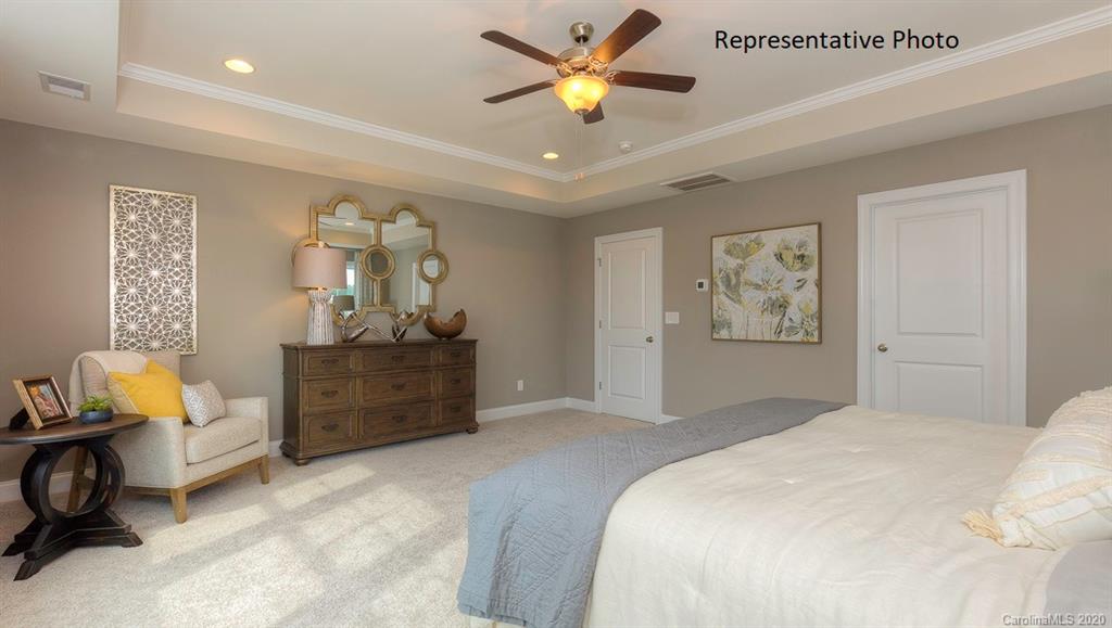 3377 Friendship Street Indian Land, SC 29707 - Photo 26 of 44 a bedroom with a bed and a chandelier
