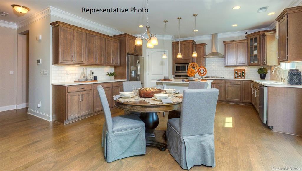 3377 Friendship Street Indian Land, SC 29707 - Photo 9 of 44 a kitchen with a table chairs refrigerator and microwave