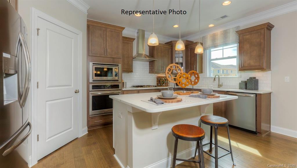 3377 Friendship Street Indian Land, SC 29707 - Photo 10 of 44 a kitchen with a stove a refrigerator and a dining table