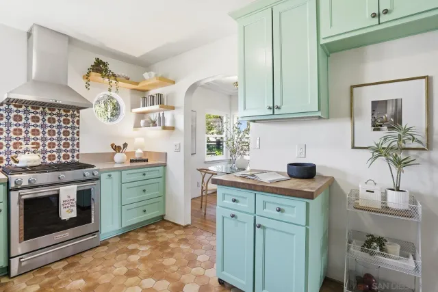 a kitchen with cabinets appliances and a sink