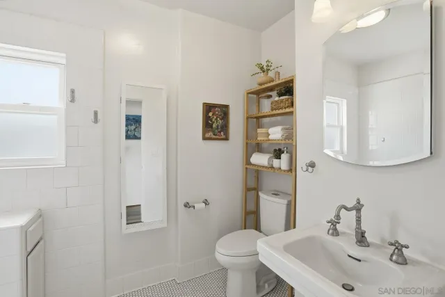 a bathroom with a sink toilet and mirror