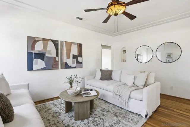 a living room with furniture and a mirror
