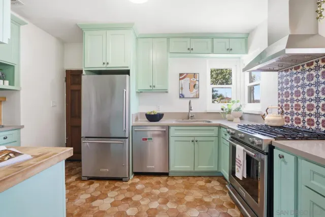 a kitchen with a sink stove and refrigerator