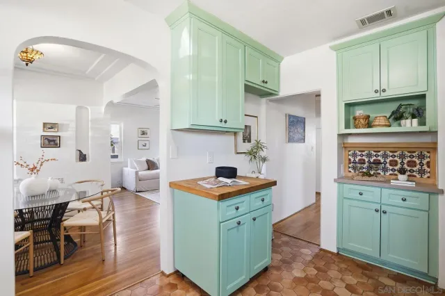 a kitchen with cabinets and a table