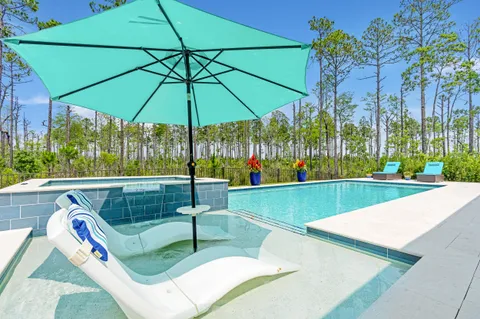 a view of a patio with a table and chairs under an umbrella