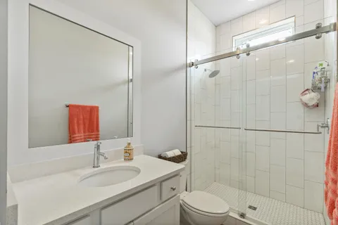 a bathroom with a toilet a sink and a mirror