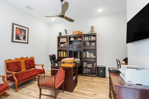 a living room with furniture a fireplace and windows
