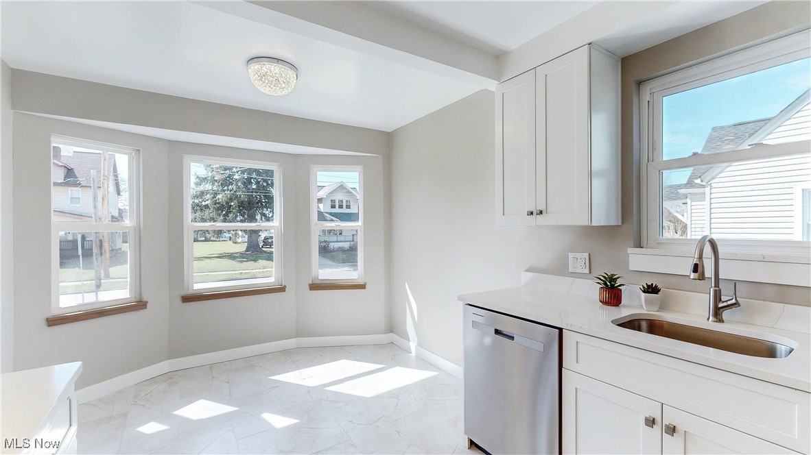 3318 Hearthstone Road Cleveland, OH 44134 - Photo 12 of 35 Main kitchen with white cabinetry, light countertops, appliances with stainless steel finishes, and a sink