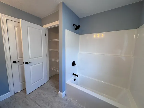 a bathroom with a bathtub and a shower