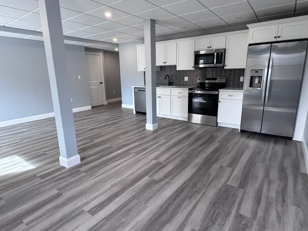 a kitchen with stainless steel appliances a refrigerator and a stove top oven