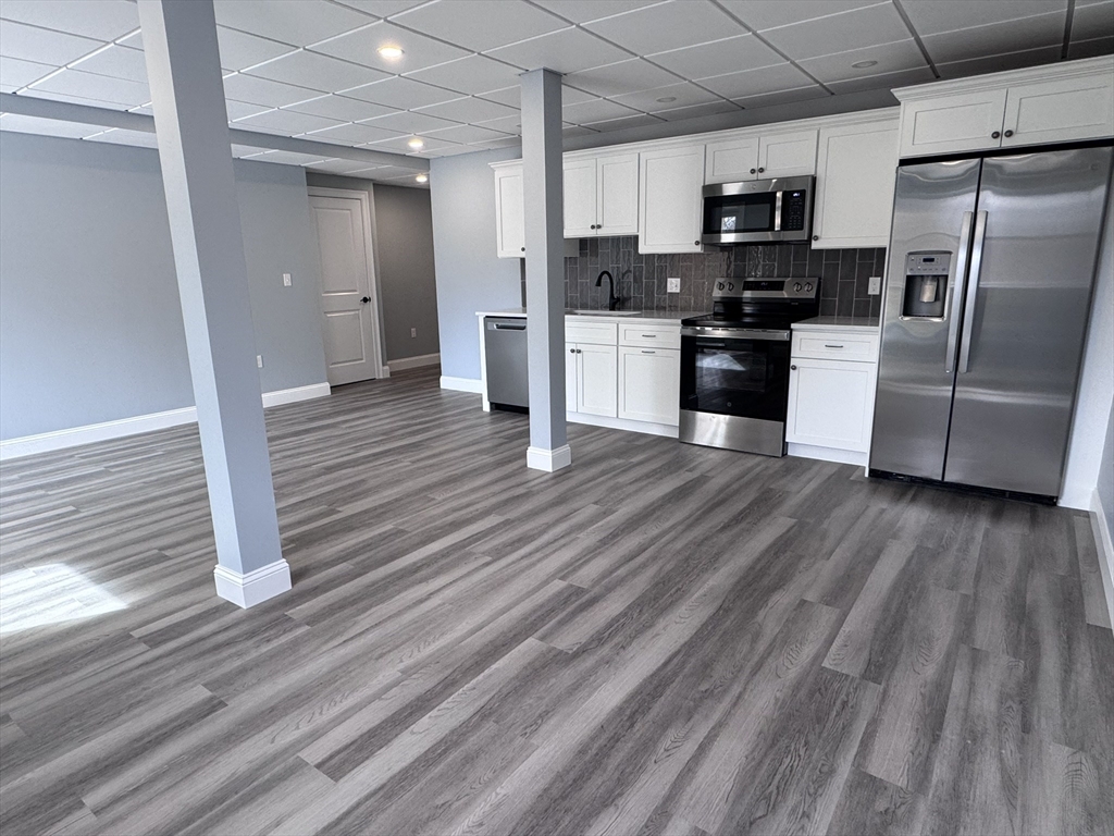 191 East Spring Street Avon, MA 02322 - Photo 21 of 33 a kitchen with stainless steel appliances a refrigerator and a stove top oven