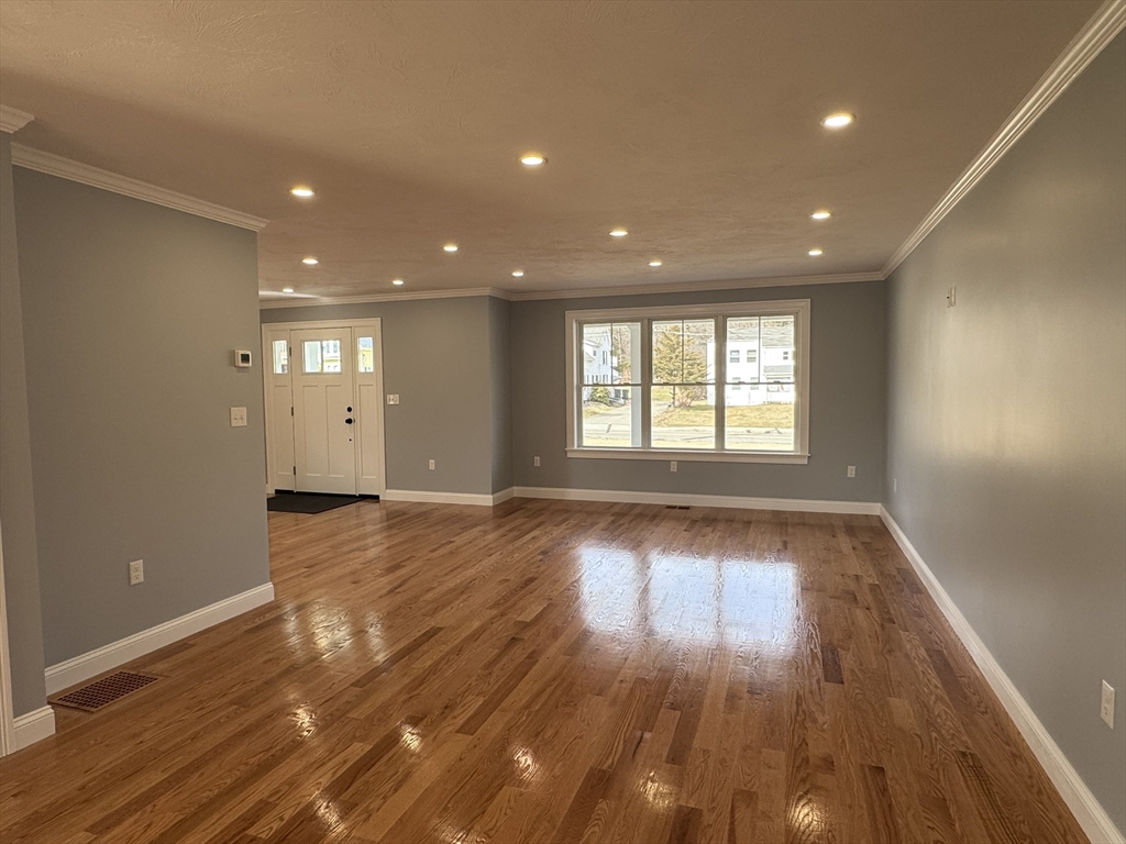 191 East Spring Street Avon, MA 02322 - Photo 6 of 33 a view of an empty room with wooden floor and a window