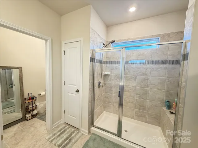 a bathroom with a shower and a sink