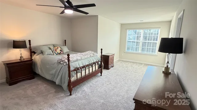 a bedroom with a bed window and a flat screen tv