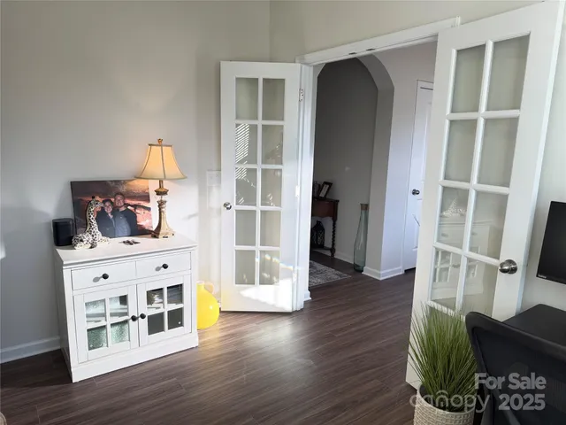 a view of a livingroom with wooden floor and furniture