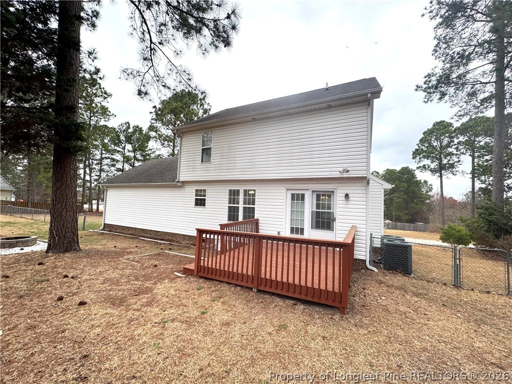 1050 Roundabout Road Cameron, NC 28326 - Photo 20 of 20 a view of a house with a deck and a yard