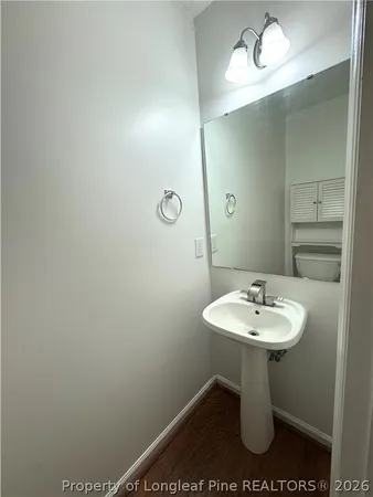 a bathroom with a sink toilet and a mirror