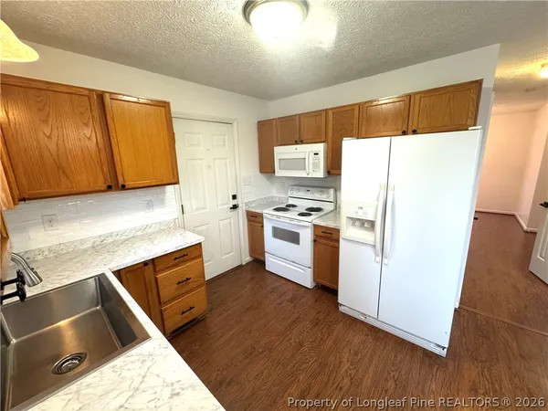 a kitchen with a refrigerator sink and stove
