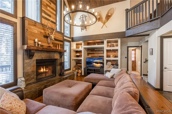 a living room with furniture a fireplace and a window