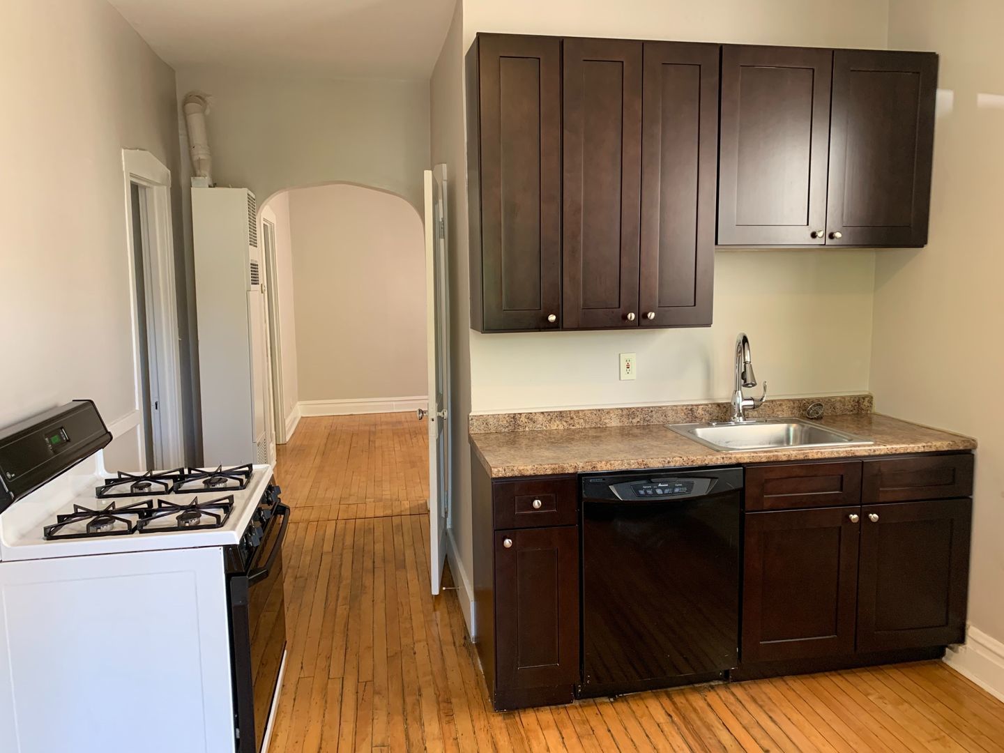 1751 West Cullerton Street, Unit 2R Chicago, IL 60608 - Photo 2 of 4 a kitchen with a sink and a stove top oven