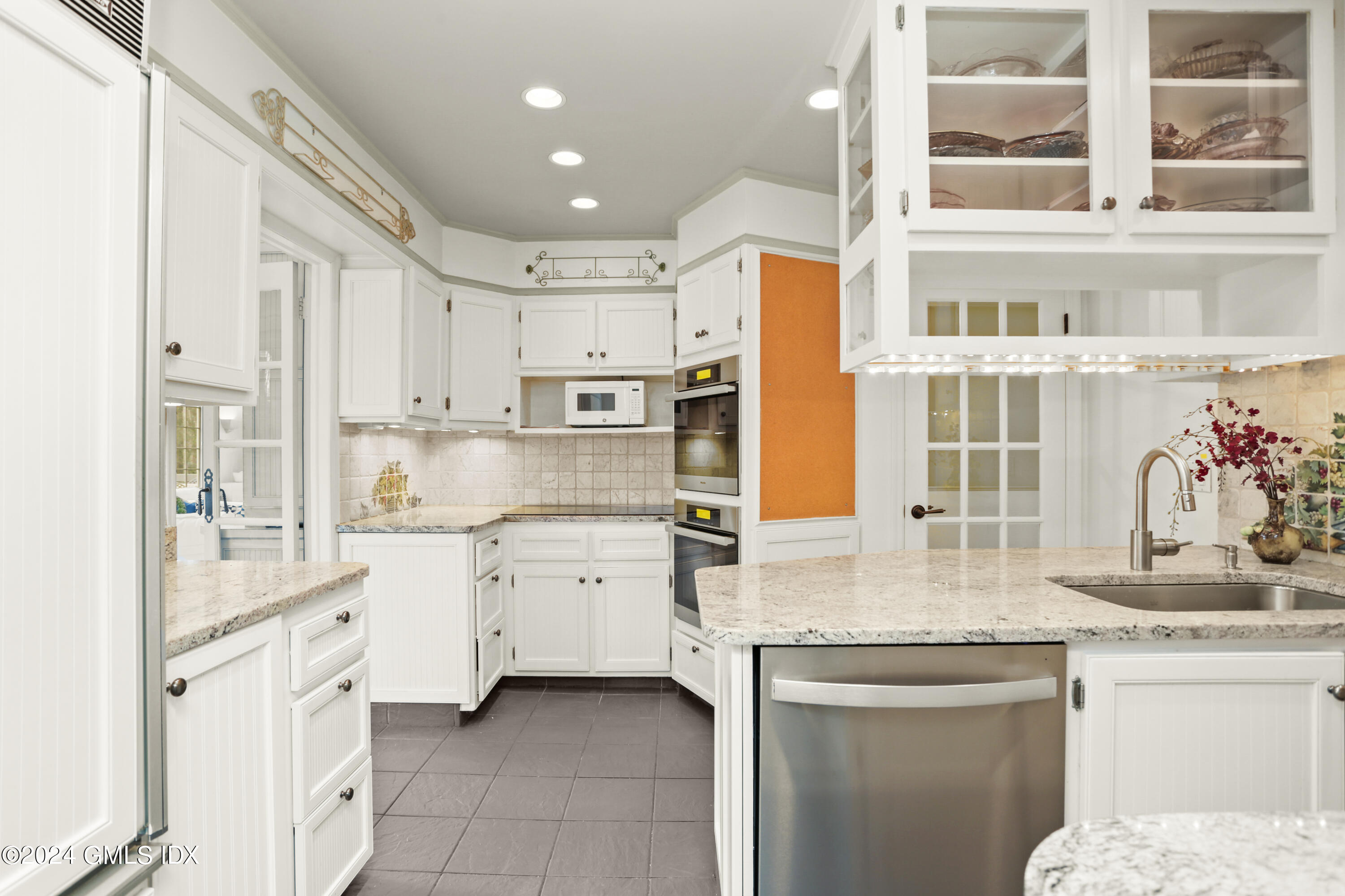 356 Haviland Road Stamford, CT 06903 - Photo 11 of 40 a kitchen with stainless steel appliances granite countertop a stove and white cabinets