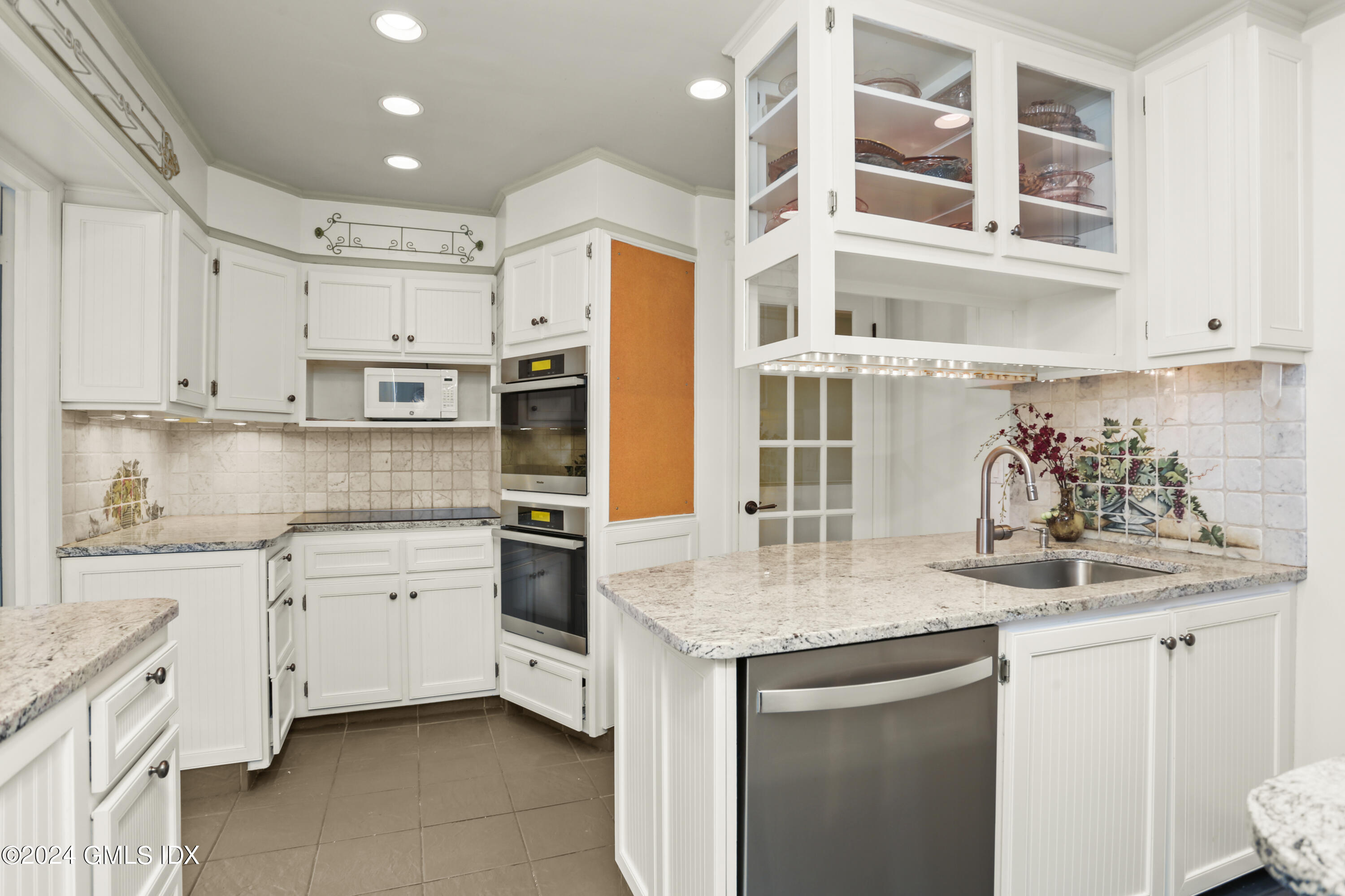 356 Haviland Road Stamford, CT 06903 - Photo 12 of 40 a kitchen with stainless steel appliances granite countertop a sink and cabinets