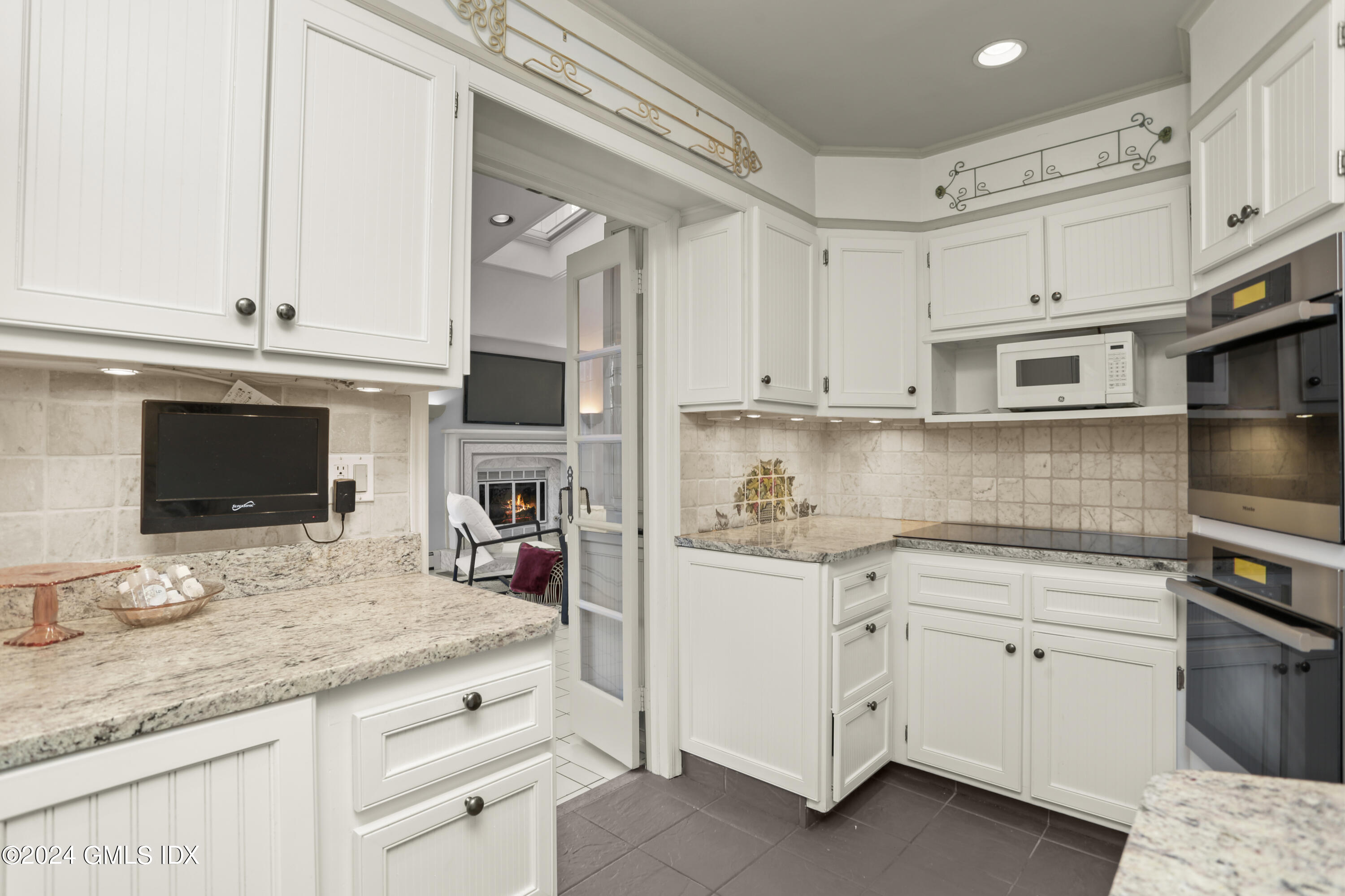 356 Haviland Road Stamford, CT 06903 - Photo 13 of 40 a kitchen with granite countertop white cabinets and white appliances