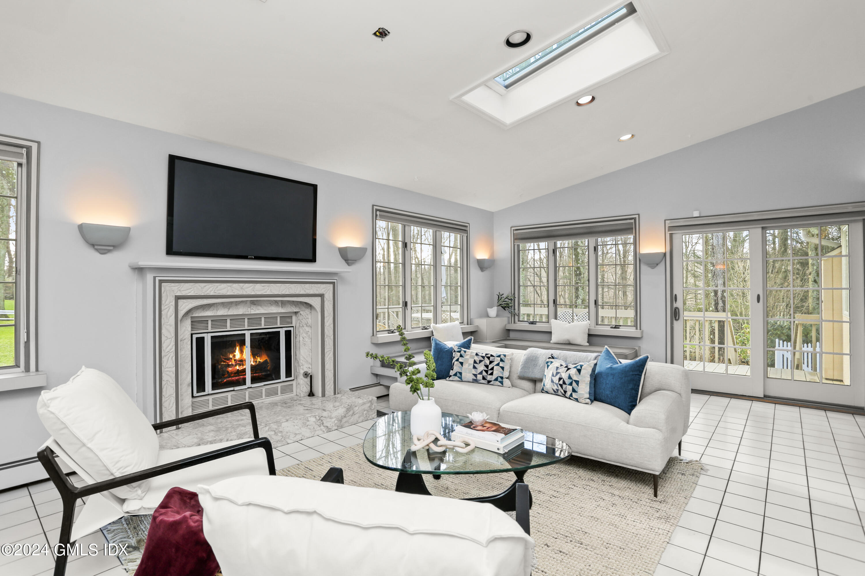 356 Haviland Road Stamford, CT 06903 - Photo 16 of 40 a living room with furniture fireplace and a flat screen tv