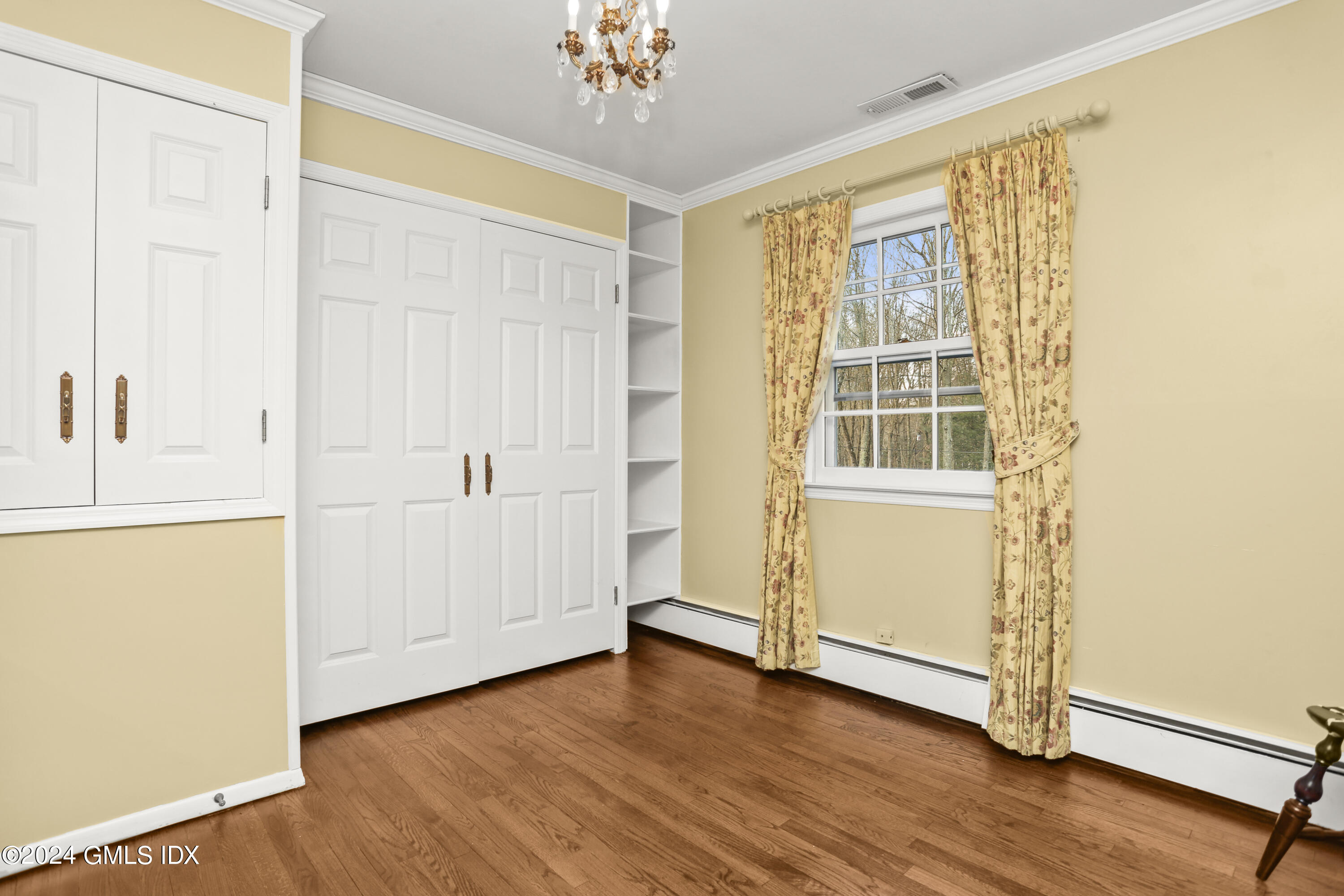 356 Haviland Road Stamford, CT 06903 - Photo 29 of 40 a view of an empty room with wooden floor and a window