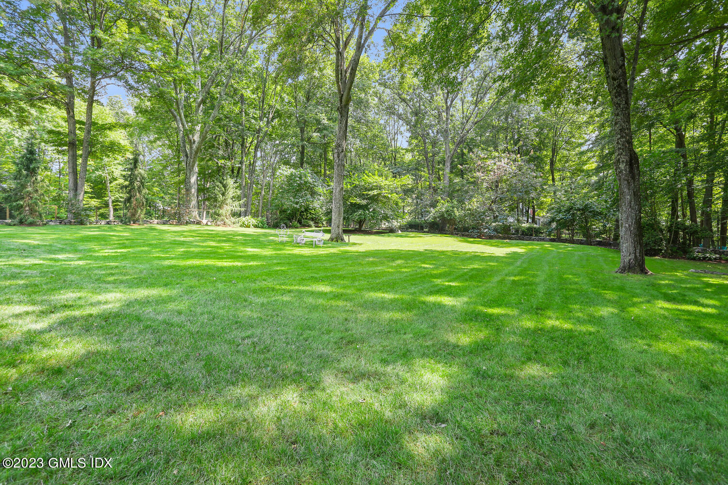 356 Haviland Road Stamford, CT 06903 - Photo 32 of 40 a view of a grassy field with trees in the background