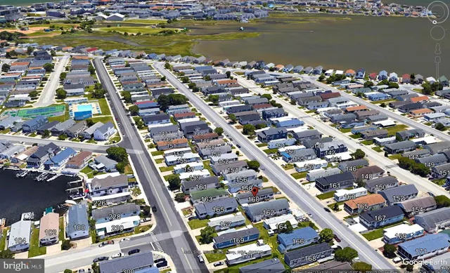 a living room with furniture a flat screen tv and a floor to ceiling window